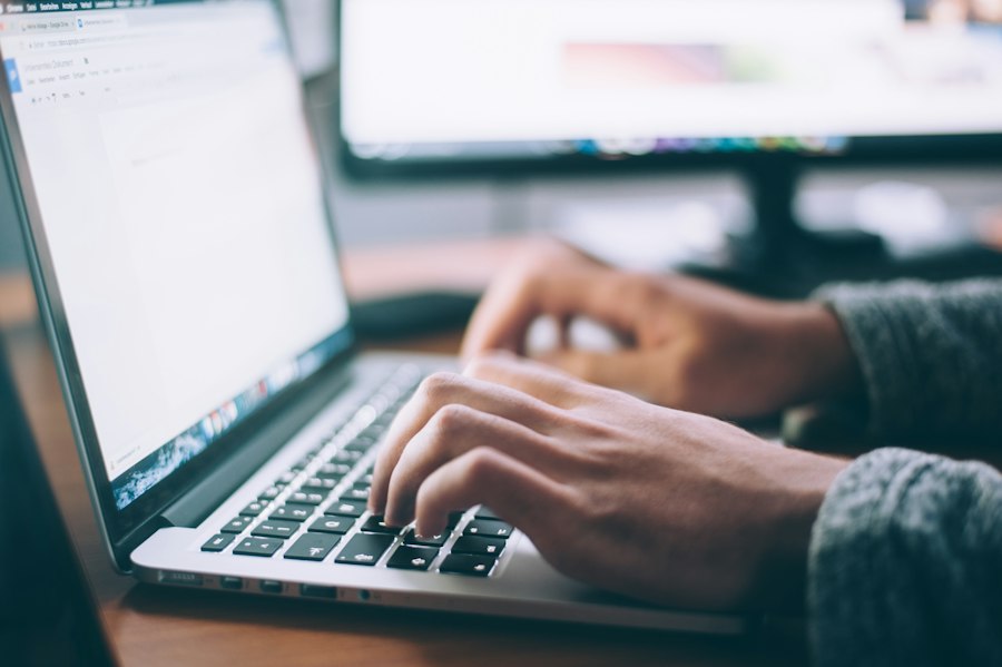 Responsive IT support engineer working quickly at a laptop
